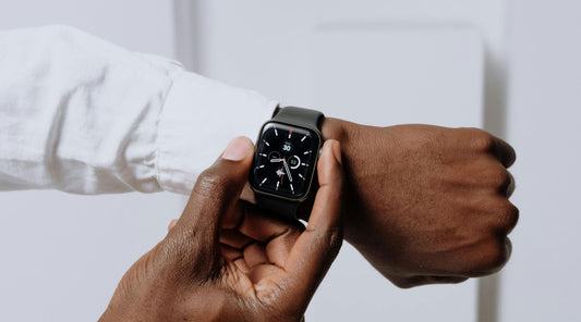 Man in White Shirt Adjusting Apple Watch with Black Silicone Apple Watch Strap